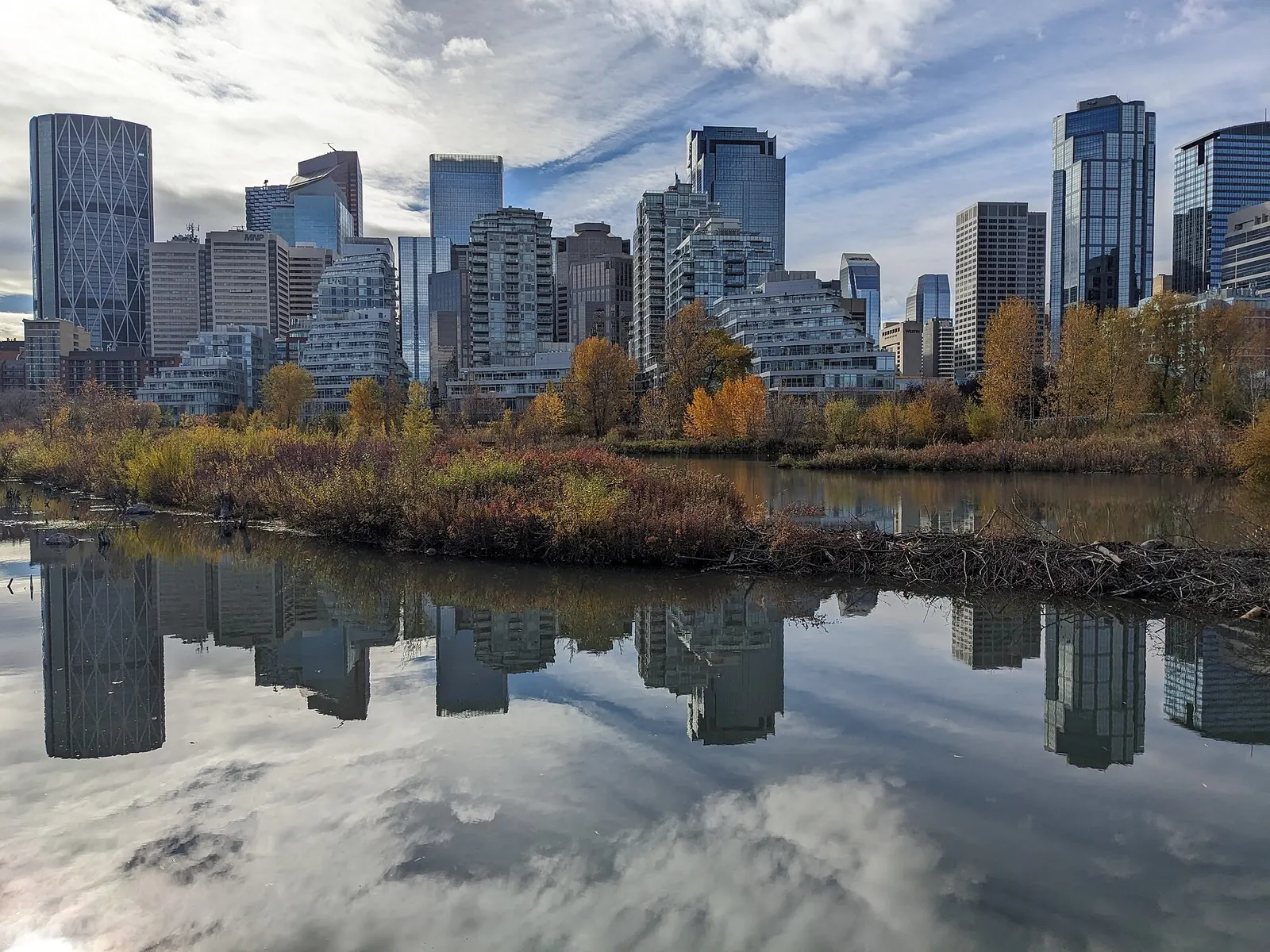 The downtown Calgary skyline reflected in the water at Prince's Island Park