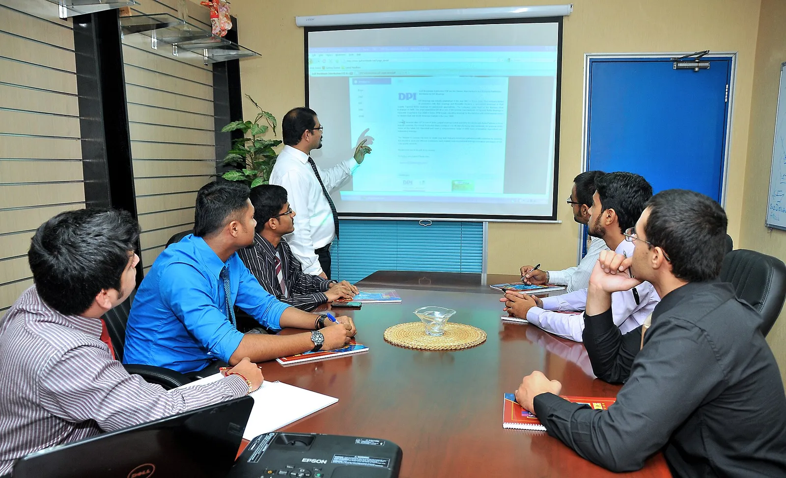 Team meeting around a boardroom table during a presentation
