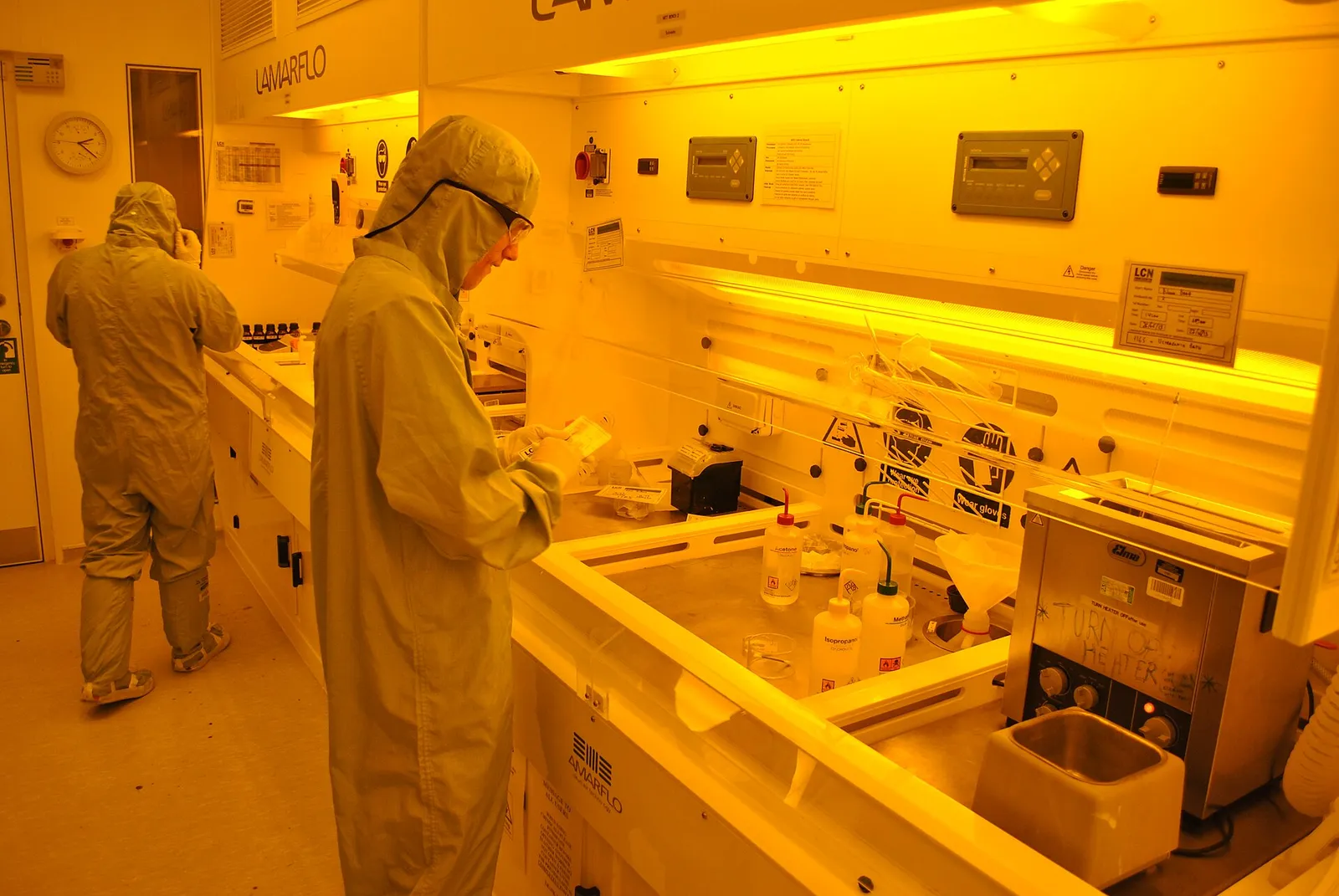 Technicians in cleanroom suits working in a laboratory
