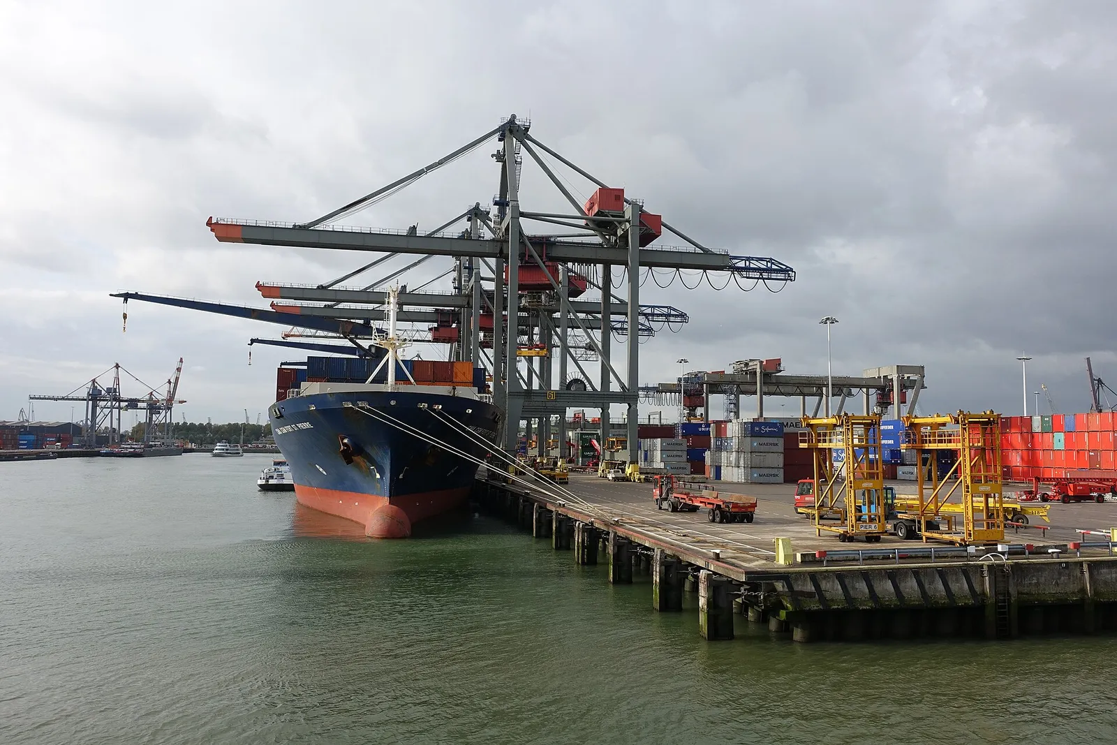 Container ship berthed under gantry cranes at a terminal